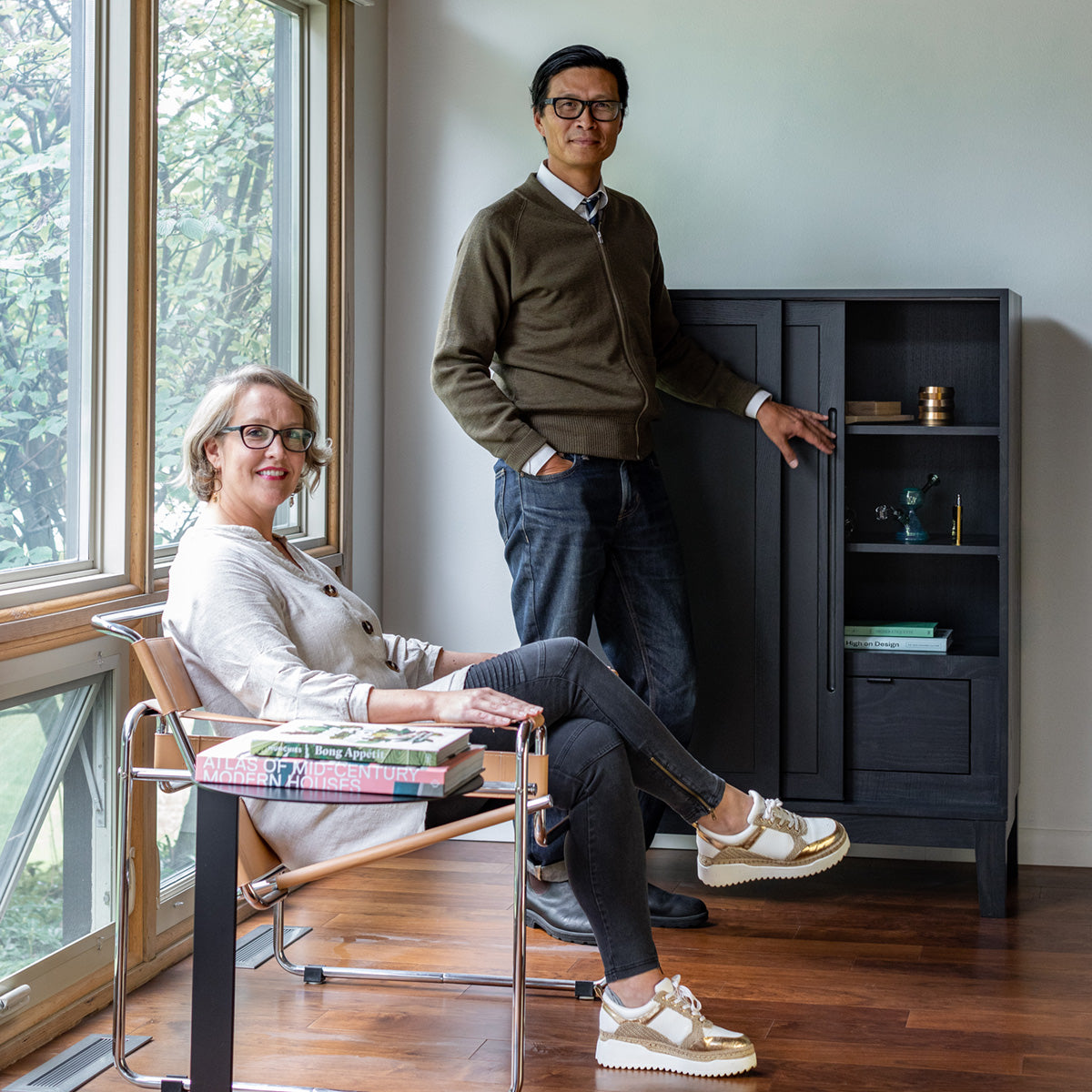 a couple in their living room with their Forti Goods small sized Geraldine in hash (black).